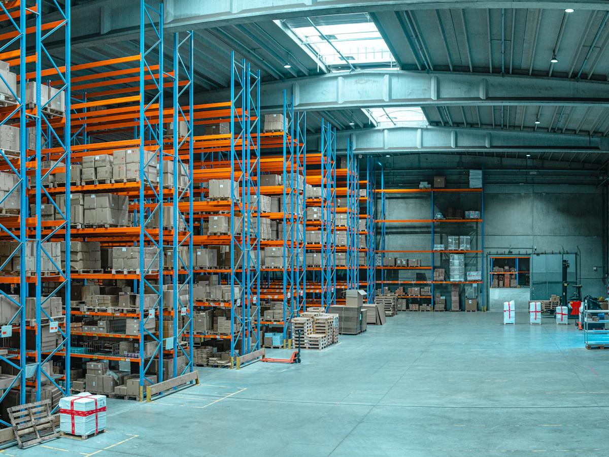 Organized warehouse shelving with boxed stock and clear picking aisles