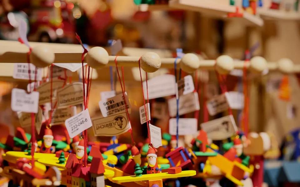 Colourful wooden toy planes and miniature houses on display